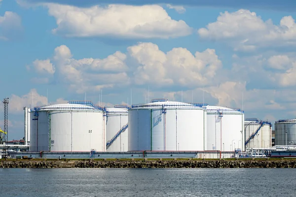Petrochemical refinery product tank farm at oil terminal for commercial trade fuel and energy transport by tanker vessel