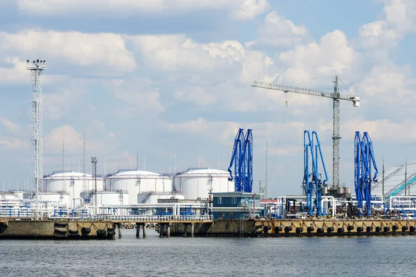 A park of chemical product tanks in the port terminal with equipment for filling liquids into ships