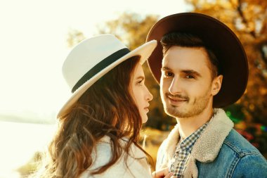 Güzel bir genç kadın ve şık giyinmiş yakışıklı bir adamın nehir boyunca romantik bir yürüyüş yaptığı portre. Aşk konsepti. 