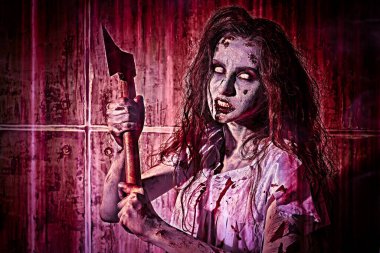 Creepy zombie woman with white eyes and shaggy hair stands in a bloody nightie with a bloody ax in her hands in red light and against a blood-covered wall. Obsessed woman. Horror, thriller. Halloween.  clipart