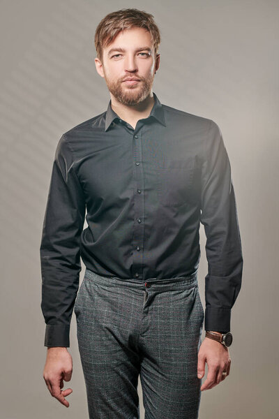 Handsome middle-aged man in classic suit seriously looking at the camera. Businessman portrait. Men's fashion.