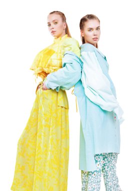 Fashion models girls pose in stylish clothes from the summer collection. Haute couture clothing. Full length studio portrait on a white background. clipart