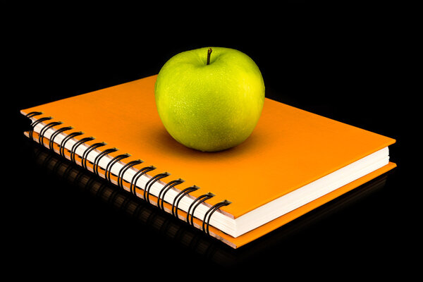Colorful book with green apple