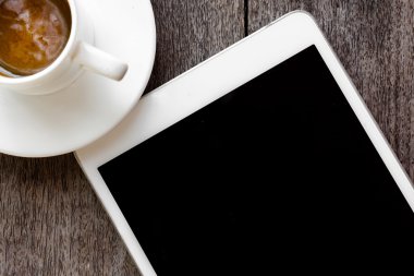 dijital beyaz tablet ve kahve fincanı ahşap tablo