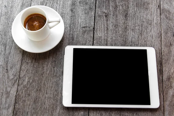 Digital white tablet and coffee cup on wooden table — Stock Photo, Image