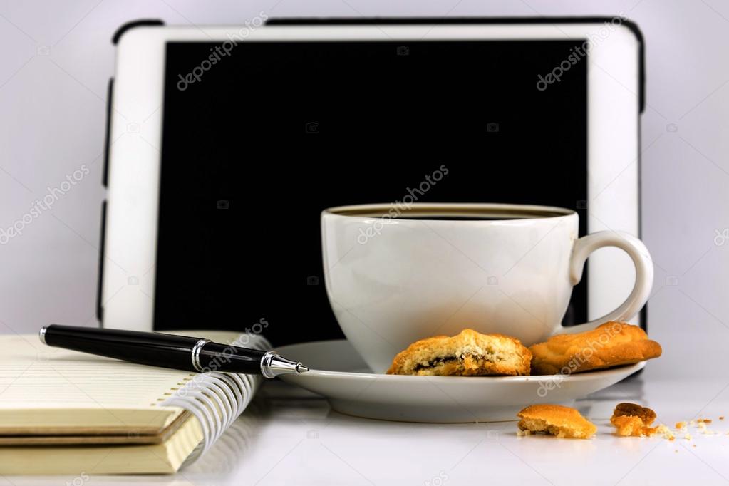 Cup of coffee,tablet computer,book and pen isolated on white bac