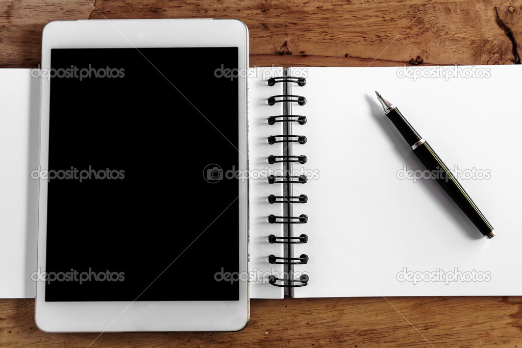 Computer screen,book and pen on wood table