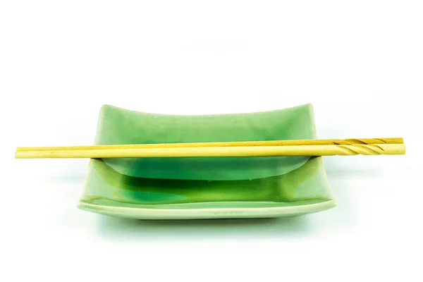 Empty green dish with chopsticks isolated on white background — Stock Photo, Image
