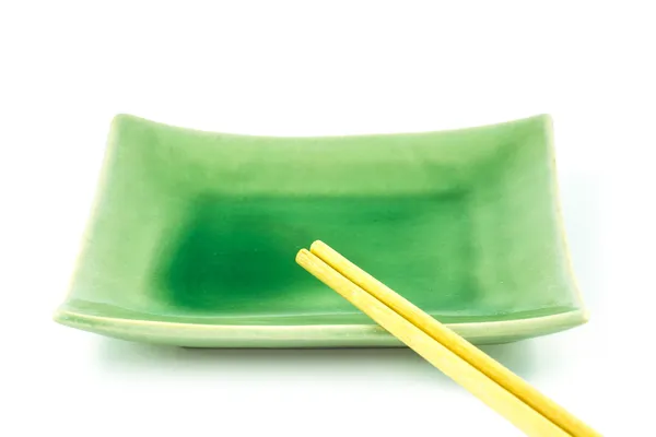 Empty green dish with chopsticks isolated on white background — Stock Photo, Image