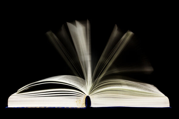 Open book isolated on black background
