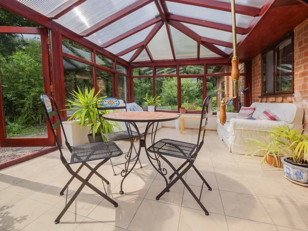 Conservatory tables chairs plants room — Stock Photo, Image