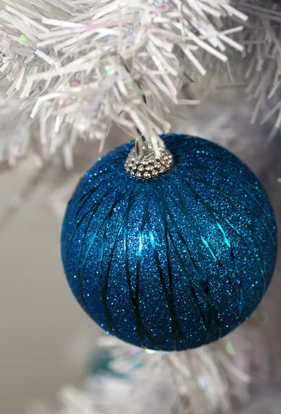 Glitter aqua ornament on white christmas tree — Stock Photo, Image