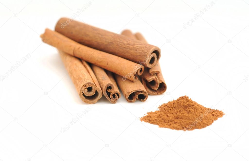 Cinnamon sticks and ground cinnamon on white