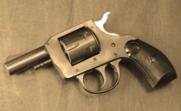 Small pistol in sepia — Stock Photo, Image