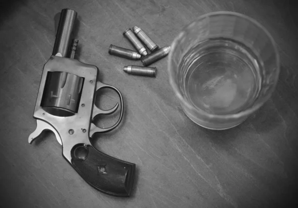 Vintage pistol or gun with booze and bullets — Stock Photo, Image