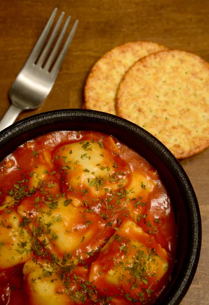 Cheese ravioli with crackers and fork — Stock Photo, Image