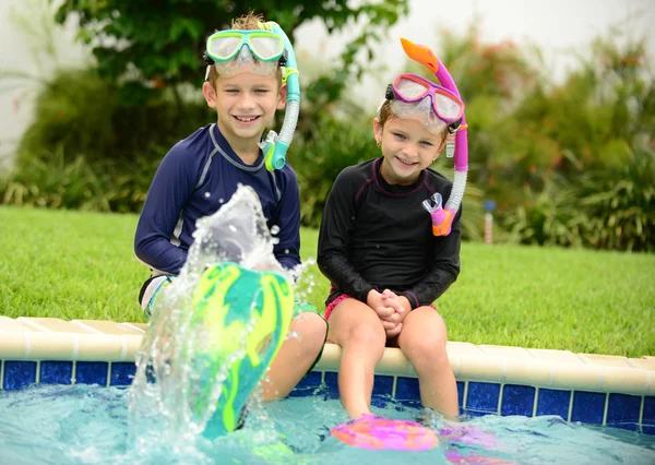 Niños salpicando en la piscina —  Fotos de Stock