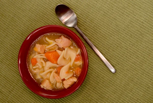 Chicken noodle soup in red bowl — Stock Photo, Image