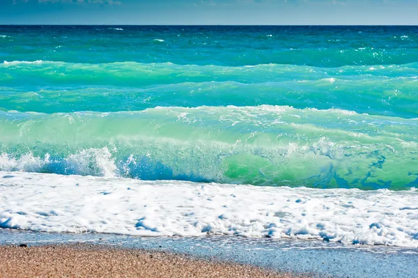 Splash de espuma do mar em uma praia arenosa — Fotografia de Stock