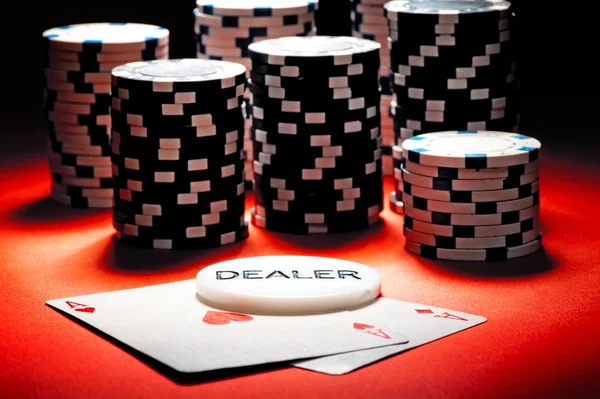 Två ess, den dealer-knapp och poker chips. — Stockfoto