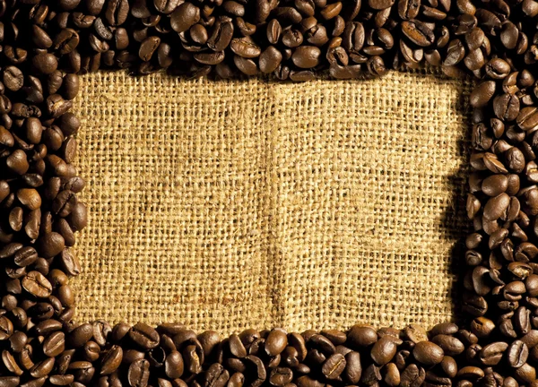 Frame of coffee beans on sacking — Stock Photo, Image