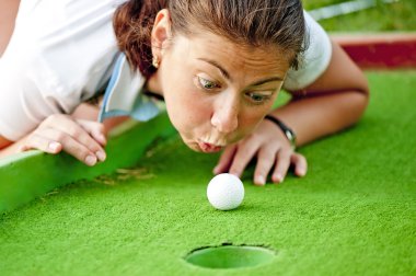 Girl cheating in the game of golf clipart