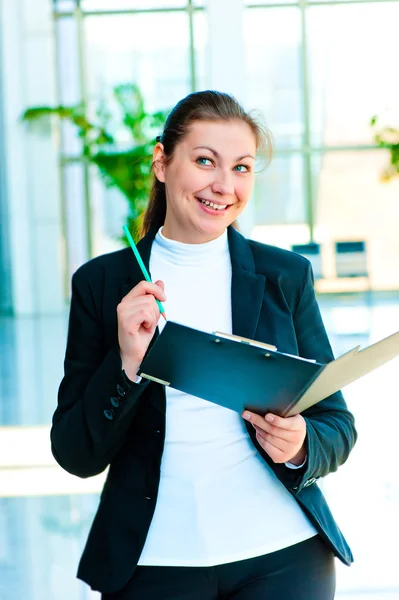 Young happy business woman with an open folder in hand — Stock Photo, Image