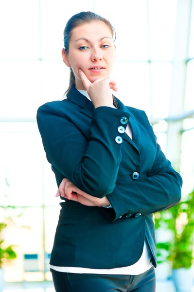 Portrait of successful businesswoman smiling on the background of a blurred office interior — Stock Photo, Image