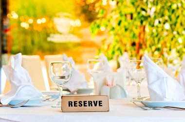 beautifully laid for supper table with a sign reserved clipart