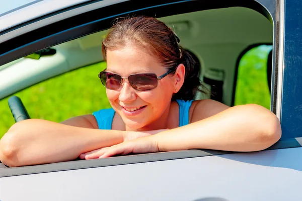 Pretty female driver in her new car — Stock Photo, Image