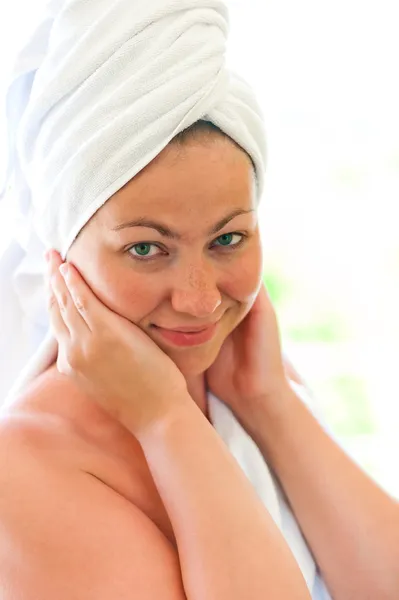 Beautiful smiling girl in a white towel — Stock Photo, Image