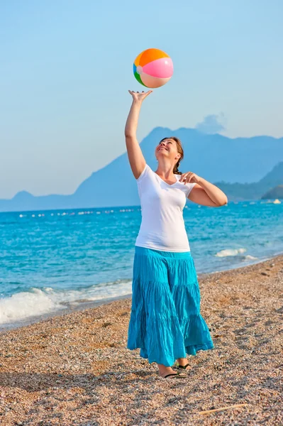 Mooi meisje op het strand bal spelen — Stockfoto