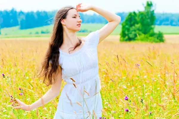 Delgada hermosa chica en el campo de flores —  Fotos de Stock