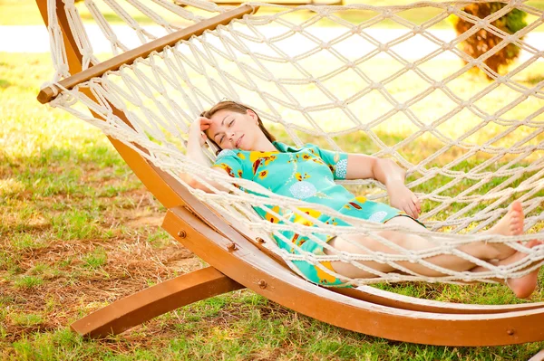 Girl in dress resting in a hammock — Stock Photo, Image