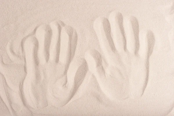 Handprints on the fine dry sand — Stock Photo, Image