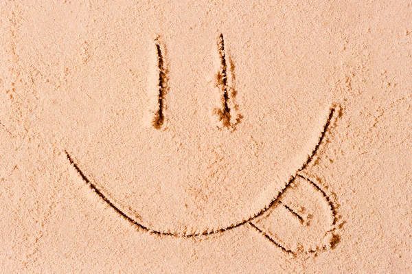 Sonriente cara con una sonrisa y su lengua colgando — Foto de Stock