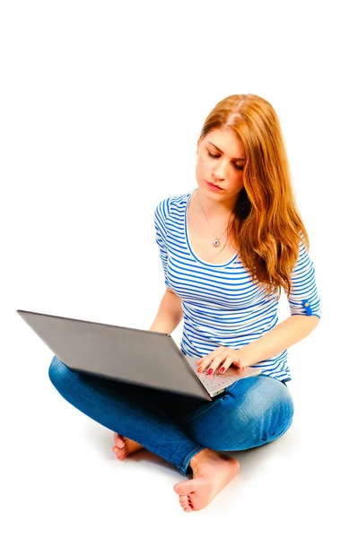 Girl in lotus position sitting at the computer — Stock Photo, Image