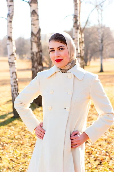 Jovem mulher de casaco branco ao ar livre — Fotografia de Stock