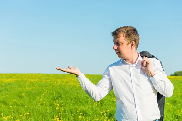 Man in a suit looks at open palm — Stock Photo, Image