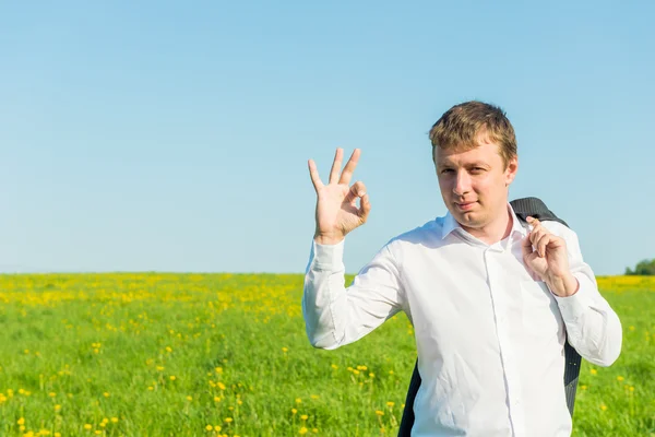 Gestures entrepreneur in the field on a sunny afternoon — Stock Photo, Image