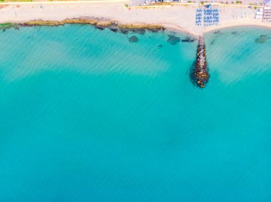 top view of the turquoise sea, sandy beach and pier