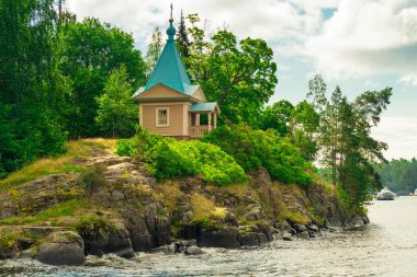 A beautiful small chapel on the shore of the lake on the island of Valaam. Karelia, Russia
