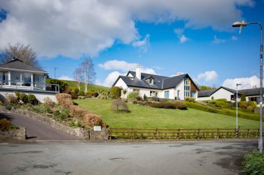 BANDON, IRELAND. APRIL 08, 2022. Beautiful Old Chapel neighborhood with houses and gardens with trees and grass at midday. Summer season in Europe. European vacation