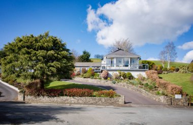 BANDON, IRELAND. APRIL 08, 2022. Beautiful Old Chapel neighborhood with houses and gardens with trees and grass at midday. Summer season in Europe. European vacation