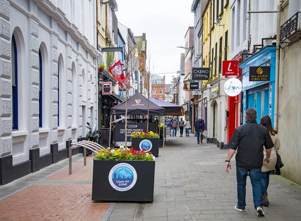 CORK, IRELAND. APRIL 04, 2022. Old city center. Small street with traditional architecture and people walking around. Spring in Europe