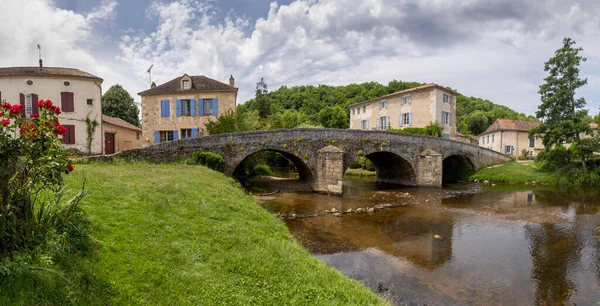 Panorama of small river La Cole with houses with blue and red shutters and a old bridge in the village of Saint-Jean-de-Cole one of the \'Plus beaux village de France\'.