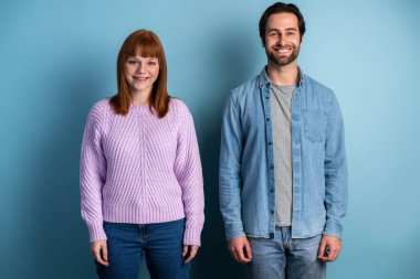 Photo of pretty lady and handsome guy couple one team members reliable workers posing isolated over blue color background 