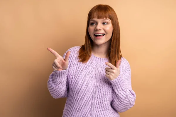 Ginger Woman Pointing Looking Away Pleasant Smile Positive Emotions Showing — Fotografia de Stock