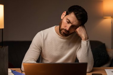 Workaholism, working on laptop. Tired stressed businessman having fatigue depression, job troubles, headache and migraine 