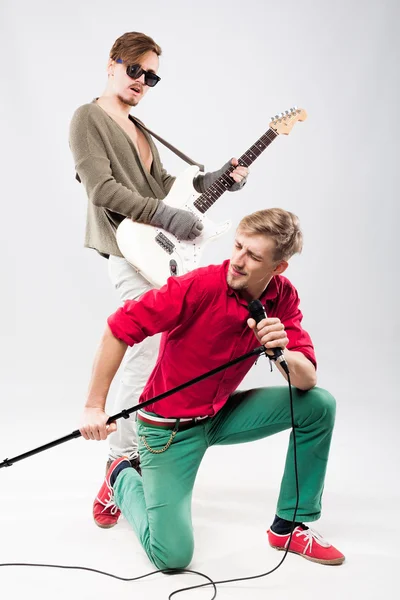 Two handsome young men with guitar and microphone — Stock Photo, Image